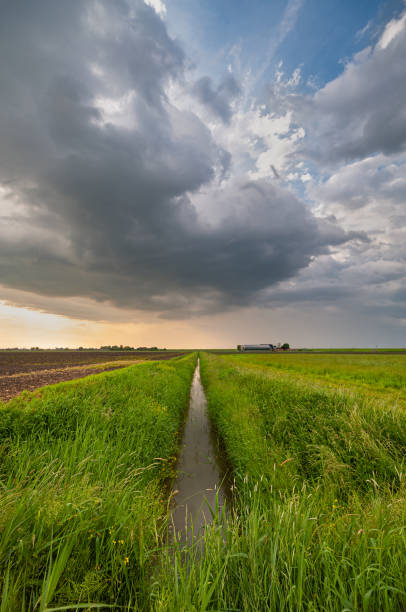istock Beautiful storm cloud above a ditch in the wide open Dutch landscape 2154101629