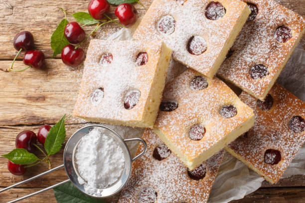 istock Czech bublanina cherry cake with sprinkled with powdered sugar closeup on the parchment. Horizontal top view 2154105921