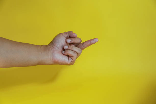 istock human hand gesturing approval expression doing okay symbol with fingers isolated on yellow background 2154107082