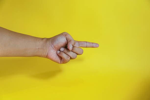 istock hand pointing on virtual object with index finger, making gesture, isolated on yellow background 2154107241
