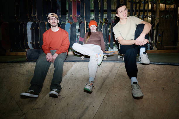 istock Three Friends Sitting In Skatepark 2154110035