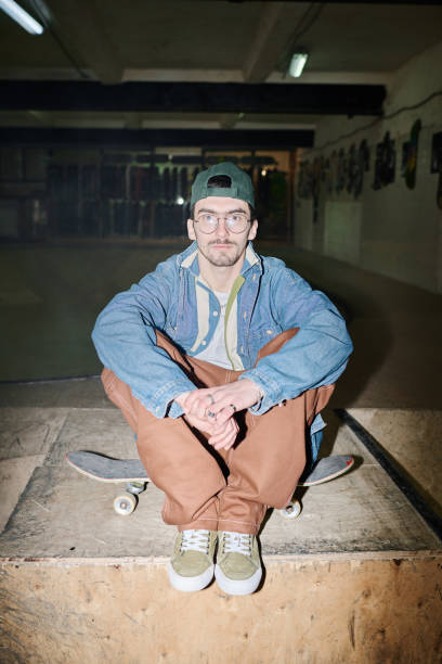 istock Young Man Sitting On Skateboard 2154110484