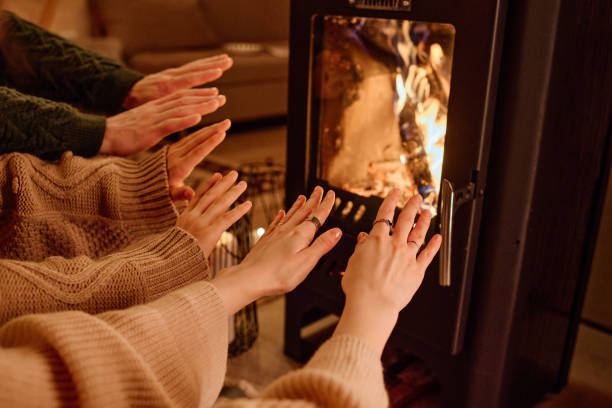 Hands Of People In Front Of Fireplace