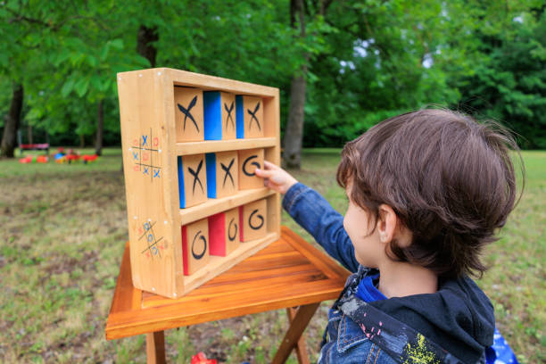 istock Child playing Tic-Tac-Toe game outdoors in park 2154111200