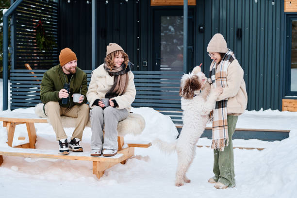 istock Parents Watching Their Daughter Playing With Dog 2154111382