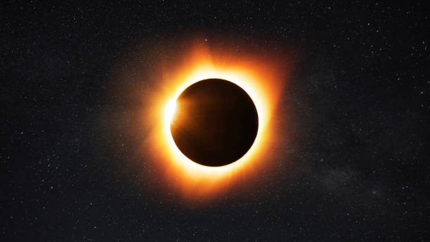 istock Amazing solar eclipse with yellow rays of light on the starry sky. Sun and moon in space 2154111641