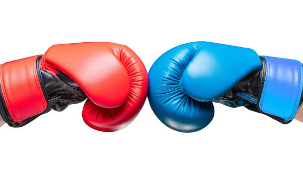 istock Conflict concept. Two hands in red and blue boxing gloves hitting each other on white background. 2154111788
