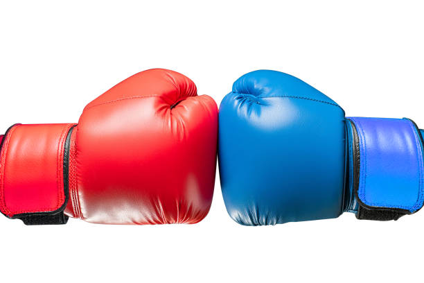 istock Conflict concept. Two hands in red and blue boxing gloves hitting each other on white background. 2154111792