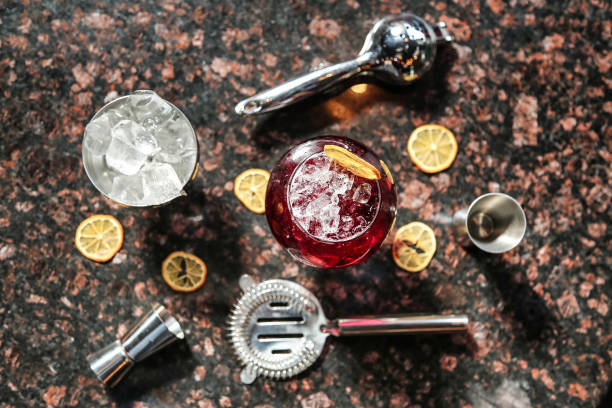 A detailed shot of a wine glass resting on a table, showcasing its elegant design and reflecting the surrounding environment.