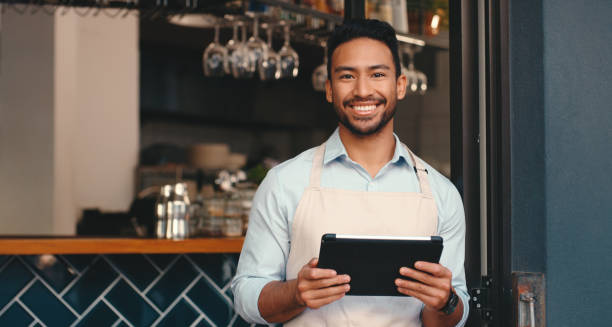 istock Asian man, waiter and tablet or restaurant worker for online booking with customer service, small business or cafe. Male person, apron and mobile app for contact us or reading, sales or hospitality 2154114069