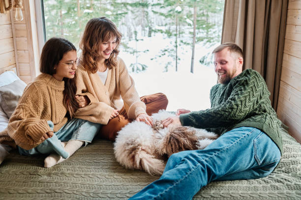 istock Family Relaxing Indoors On Winter Day 2154114241