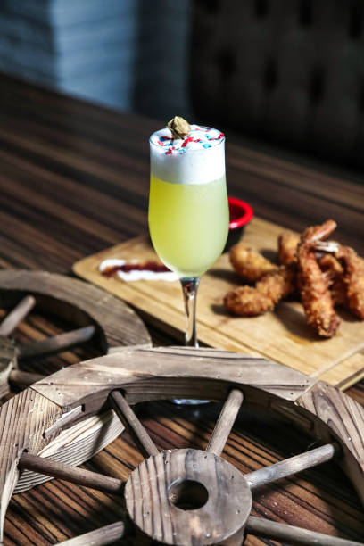 A table topped with a plate of food and a drink, showcasing a delicious meal.