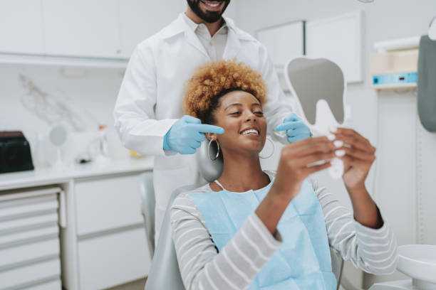 istock Woman at dentist holding mirror 2154116649