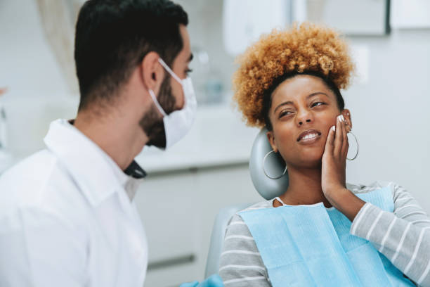 istock woman at the dentist with toothache 2154117613