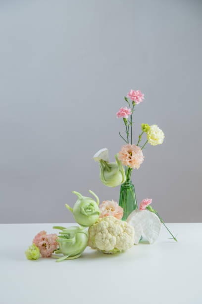 istock unusual composition of flowers, vegetables and cheese 2154117624