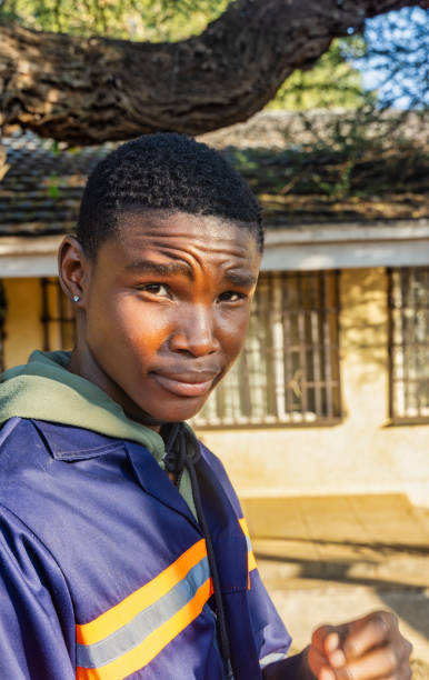 istock young african worker in workwear in the yard, at sunset 2154118455