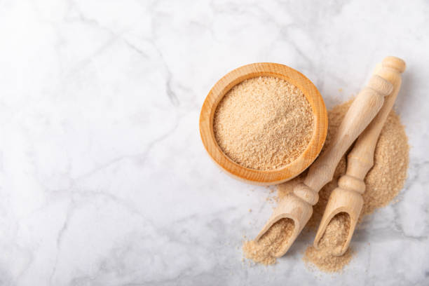 istock Cinnamon sugar on a texture background. Homemade cinnamon sugar in a bowl on background. Brown sugar. Spice mixture for drinks and baking. Place for text. Copy space. 2154120544