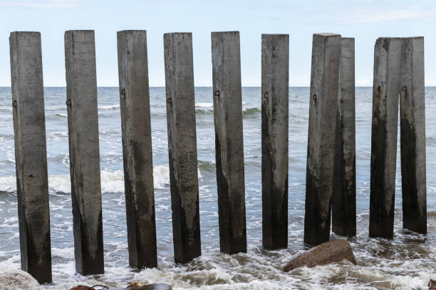 istock Dark concrete pillars as a part of the breakwater structure 2154120629