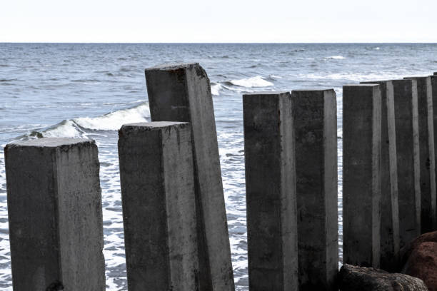 istock Dark concrete pillars as a part of breakwater structure are at Baltic Sea 2154120632