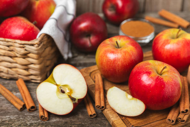 istock Apples with cinnamon on a textured wooden background. Fragrant red spiced apples with cinnamon sticks and star anise. Apple slices with spicy spices. Place for text. Copy space. Harvesting. Fruits. 2154120767