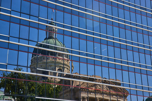 istock Modern Meets Historic: Reflection of Ornate Courthouse in Glass Skyscraper 2154122230