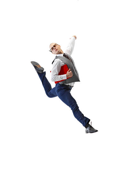Young man dressed formal outfit and leaping in motion holding red folder against white studio background. Concept of business, work and study, hobby, freelance, office. Ad