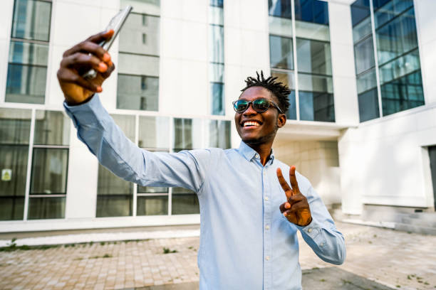 istock Smiling man taking selfies outdoors 2154123499