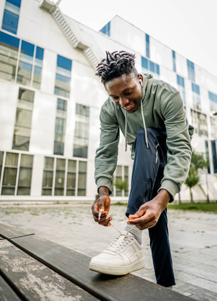 istock Man tying his shoelace outdoors 2154123552