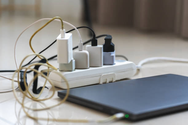 istock Electrical outlet with many chargers connected to it for a smartphone, laptop, microphone 2154123661