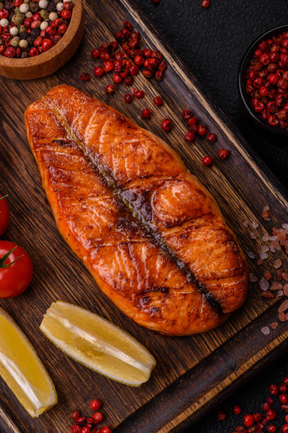 istock Fresh cooked delicious salmon steak with spices and herbs 2154123850