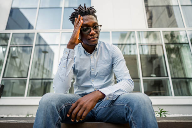 istock Upset man sitting on the bench in the city 2154123913