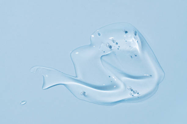 istock Cream gel blue transparent cosmetic sample texture with bubbles on blue background 2154124311