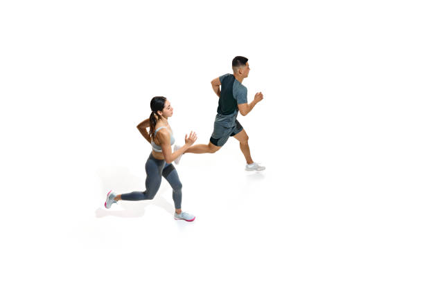 istock View from above woman and man running with powerful strides, showcasing their athletic strength against white studio background. 2154124721