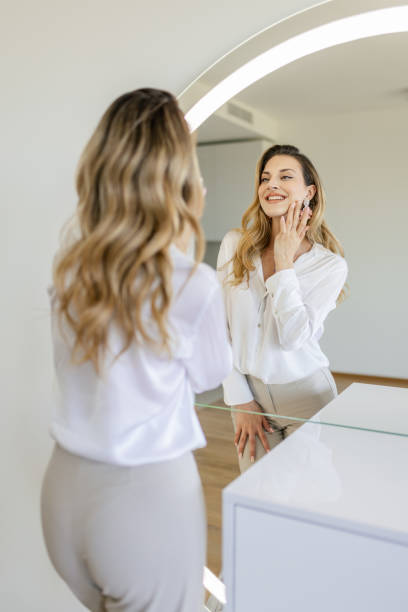 istock Young woman getting ready in front of a mirror 2154126174