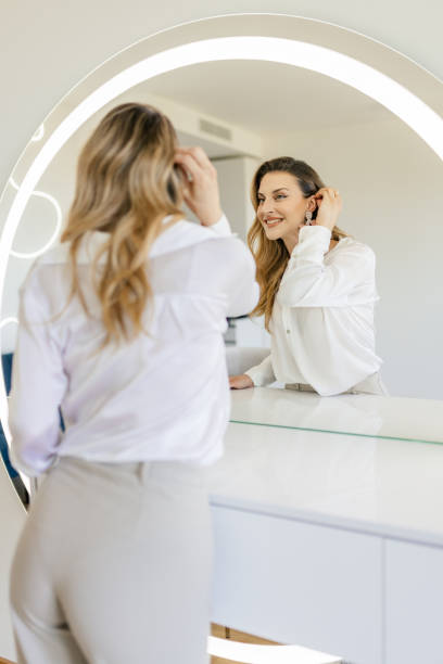 istock Young woman getting ready in front of a mirror 2154126194