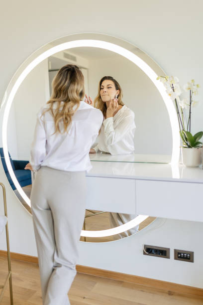 istock Young woman getting ready in front of a mirror 2154126204