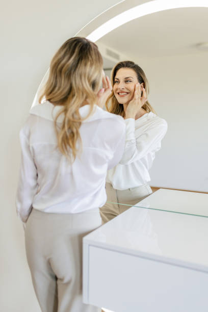 istock Young woman getting ready in front of a mirror 2154126208