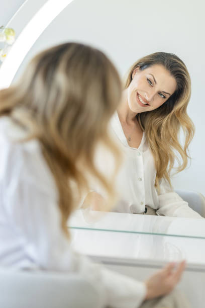 istock Young woman sitting in front a mirror 2154126225