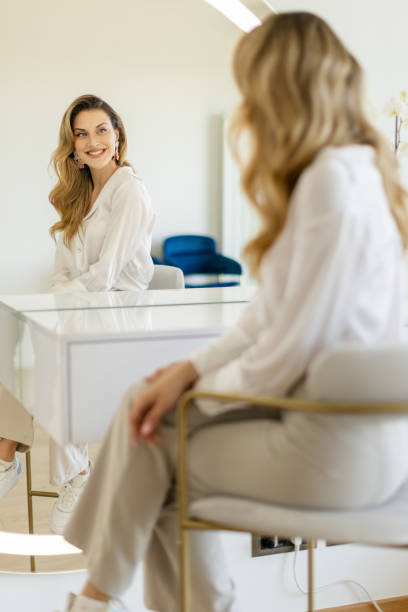 istock Young woman sitting in front a mirror 2154126250