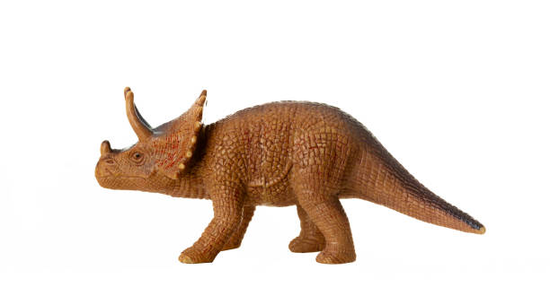 Dinosaur toys in Christmas Santa hats behave  like they are having fun at a Christmas party.