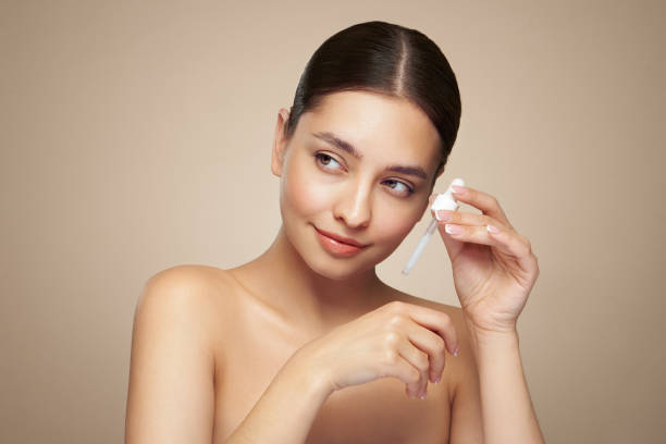 istock Young beautiful woman applying face serum 2154129819