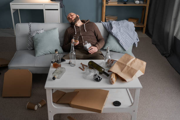istock After drinking. Drunk bearded man sitting on sofa and sleeping after drinking alcohol, high angle 2154133314