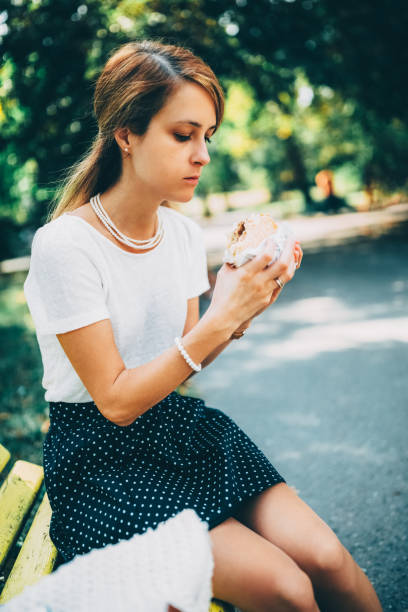 Pretty 18-year-old girl admiring the first sausage roll she's ever cooked.