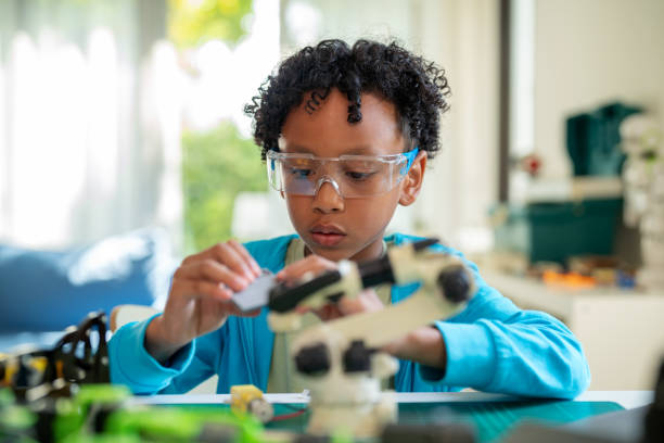 istock A talented African boy is engrossed in designing prototype robots on his computer during a school break. Child's focus and enthusiasm for robotics and technology, highlighting his engagement in e-learning and STEM topics. 2154134649