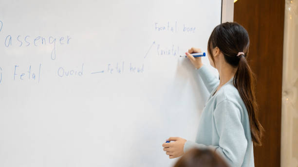 istock A girl is writing on a white board 2154135228