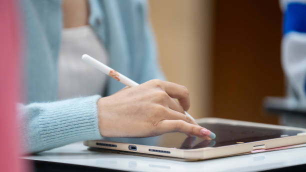 istock A woman is writing on a tablet with a white pen 2154135305