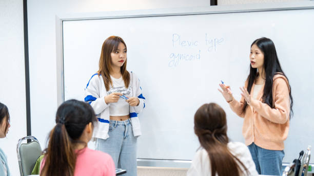 istock Two women are standing in front of a white board 2154135307