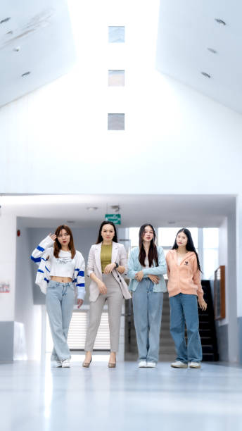 istock Four women are walking down a hallway in a building 2154135830