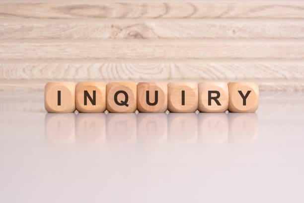 istock wooden blocks displaying the word 'Inquiry' arranged on a glossy gray surface 2154136514