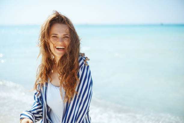 istock smiling modern woman on seacoast having fun time 2154138021